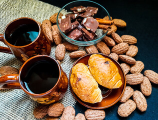 Breakfast. Coffee with cinnamon, croissants, chocolate and sweets for two. Top view
