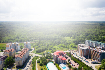 European city with new houses and construction site with unfinished building. Aerial view