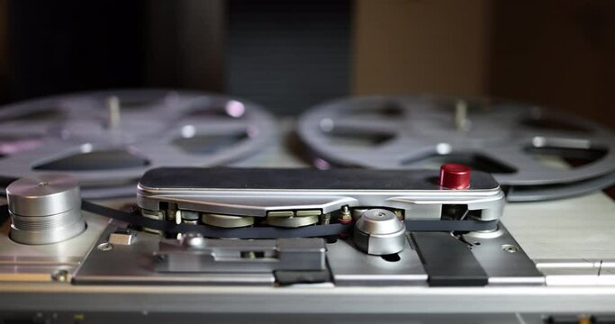 Close up side tracking left to right shot on a vintage professional audio tape recorder