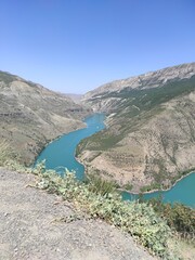 Fototapeta na wymiar deep canyon with blue river and mountains