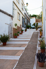 Beautiful street at Alvor. White houses, pots with plants. Portimao, Algarve, Portugal, Europe