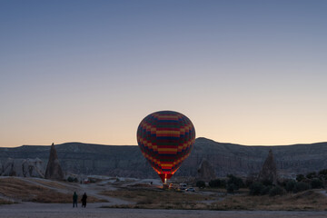 Goreme, TURKEY - August 27, 2020: Launching balloons, preparing for departure and receiving tourists on board. Early morning Sunrise in Cappadocia