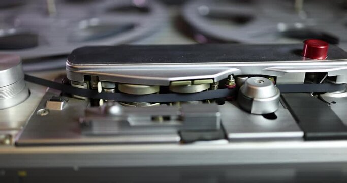 Close up side tracking left to right shot on a vintage professional audio tape recorder
