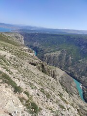 deep canyon with blue river and mountains