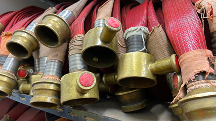 Roll-up fire hose compartment on fire equipment storage rack