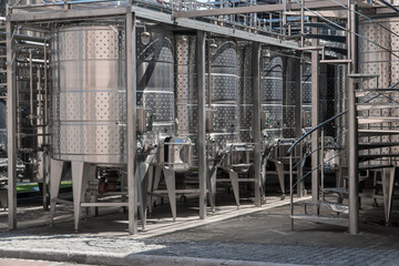 Stainless steel barrels for wine fermentation at a winery.