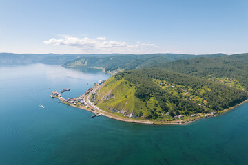 Obraz premium Lake Baikal is a marvelous blue jewel framed by scenic mountains and forests. Epic cinematic aerial view Lake Baikal. Aerial view of blue lake and green forests.