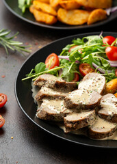 Roast Pork Tenderloin in mustard gravy with vegetables and potato wedges