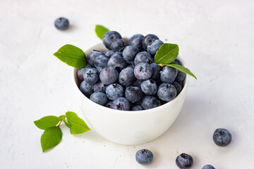 Blueberries in a cup on a white background