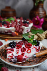 Vertical composition. Close-up shot of an appetizing piece of curd pie with raspberries on a rustic background