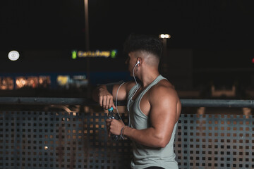 a young Moroccan athlete training at night on a public road.