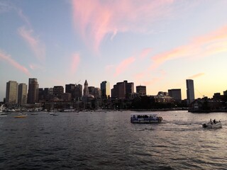 Colorful sunset over Boston skyline from the sea