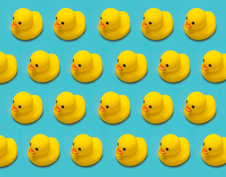 many toy rubber ducklings isolated on blue background pattern, horizontal
