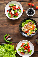 salads menu different types of vegetables, meat, herbs fresh portion ready to eat meal snack on the table copy space food background rustic. top view keto or paleo diet