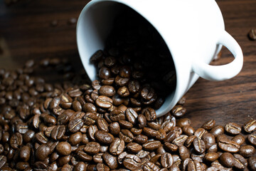 Cup of coffee full of coffee beans.