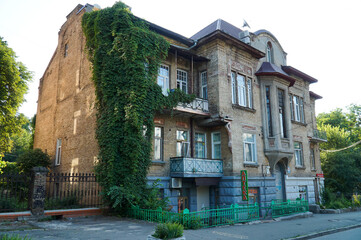 A beautiful old residential building in Kiev, entwined with ivy.
