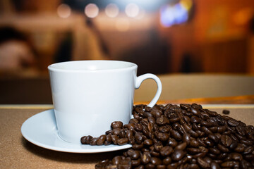 Cup of coffee full of coffee beans.