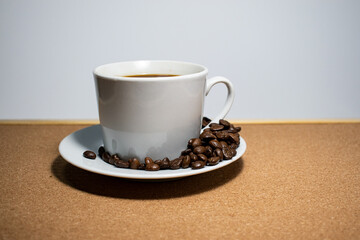 Coffee cup and coffee beans on white background