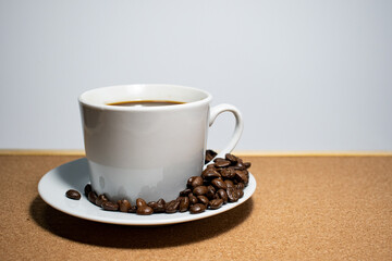 Coffee cup and coffee beans on white background