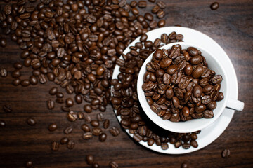 Cup of coffee full of coffee beans.