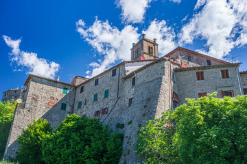 Italian medieval village details, historical stone church and abbey, old city stone buildings architecture. Santa Fiora, Tuscany, Italy.