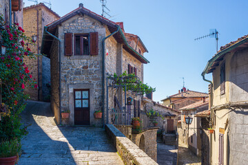 Italian medieval village details, historical stone alley, ancient marrow street, old city stone buildings architecture. Santa Fiora, Tuscany, Italy.