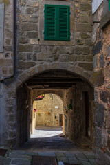 Italian medieval village details, historical stone arch, ancient gate, old city stone buildings architecture. Santa Fiora, Tuscany, Italy.