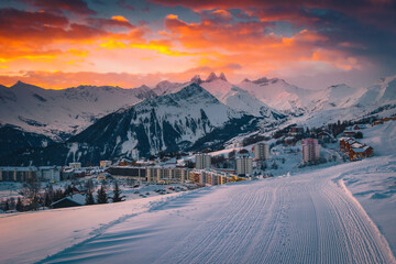 Popular alpine ski resort with colorful sunrise, La Toussuire, France - 453665511