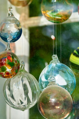 Multicolored glass balls in the window of a glass blowing workshop