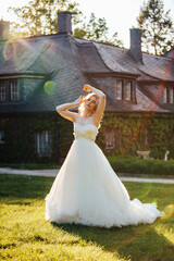 blond bride in wedding dress at a sunny day