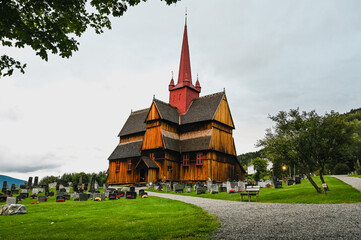 Fototapeta na wymiar Ringebu Stave Church (Ringebu Stavkyrkje) under a cloudy sky.