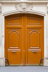 Paris, an ancient wooden door, beautiful facade in the Opera district
