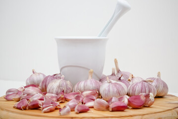 cabeça de alho sobre a mesa com moedor de tempero. 
