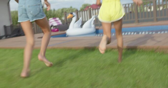feet of children running to pool