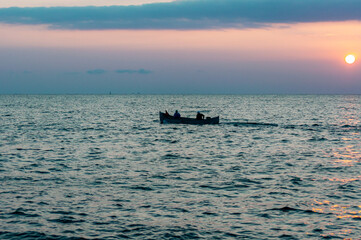 A fisherman boat on the Black sea at the sundawn