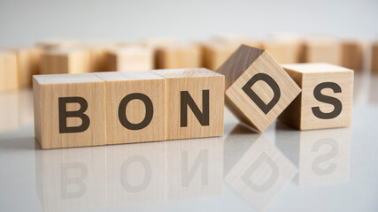 Wooden blocks with the word Bonds. Equivalent loan. Unsecured and secured bonds