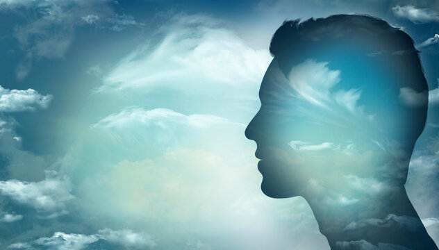 Man head profile silhouette with sky and clouds background.Concept of thinking - psychology - imagination.Mental disorder metaphor - mental health - bipolar disease.Psychiatry.Personality