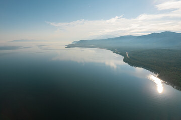 Fantastic panorama of Lake Baikal at sunset is a rift lake located in southern Siberia, Russia. Baikal lake summer landscape view. Drone's Eye View.