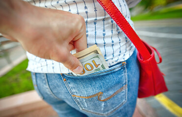 Pickpocketing, thief stealing cash from back pocket in the street. Stealing money, street robbery....