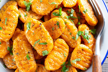 Pumpkin gnocchi on the plate, closeup