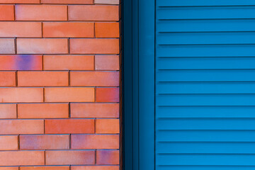 Classic bricks and blue wooden door. Photo of two textures.