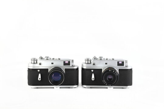 Old film photo rangefinder cameras on white background.