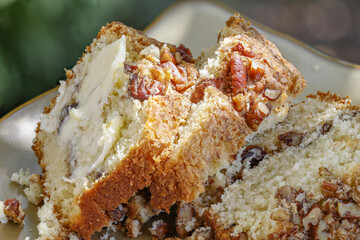 Three slices of Coffee Cake layered with pecans and brown sugar and a slice of butter