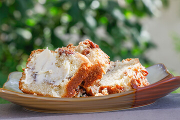 Three slices of Coffee Cake layered with pecans and brown sugar and a slice of butter