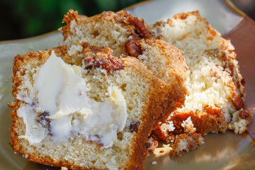 Three slices of Coffee Cake layered with pecans and brown sugar and a slice of butter