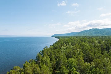 Fotobehang Summertime imagery of Lake Baikal is a rift lake located in southern Siberia, Russia Baikal lake summer landscape view from a cliff near Grandma's Bay. Drone's Eye View. © Quatrox Production