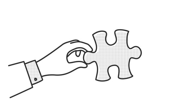 Businessman hand is holding a puzzle piece.