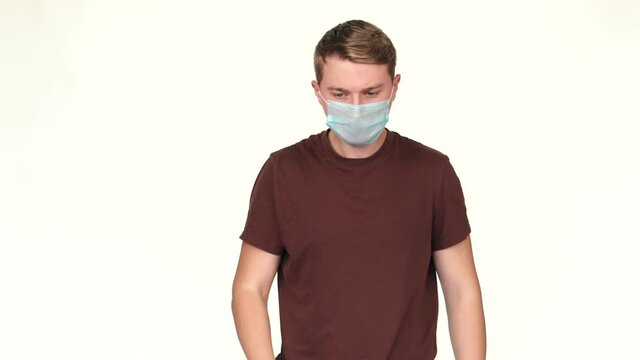 Footage of young man cough and wearing facial mask for protection.