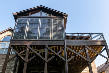 Wooden porch architecture with covered structure with gable roof. Building addition concept.