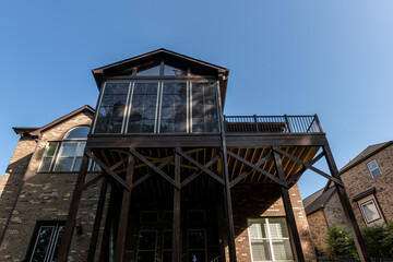 Wooden porch architecture with covered structure with gable roof. Building addition concept.